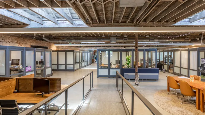 Shared workspace with exposed timber and glass offices